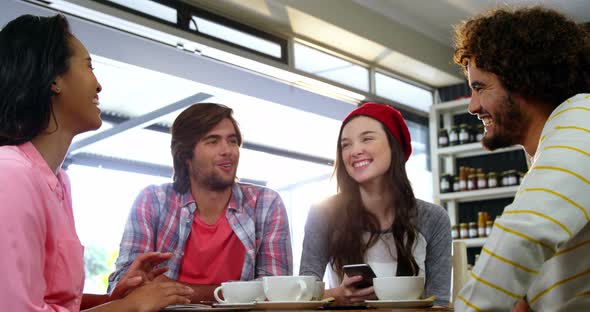 Friends interacting while having coffee