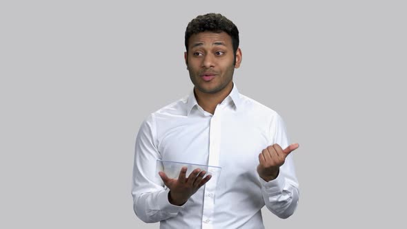 Young Hindu Guy Guy Giving Speech Holding Tablet Pc