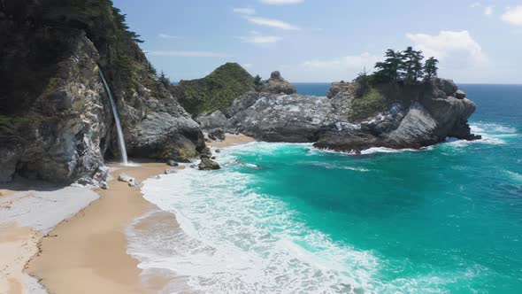 Amazing Aerial of the Wild Nature with Waterfall Falling Into the Blue Ocean