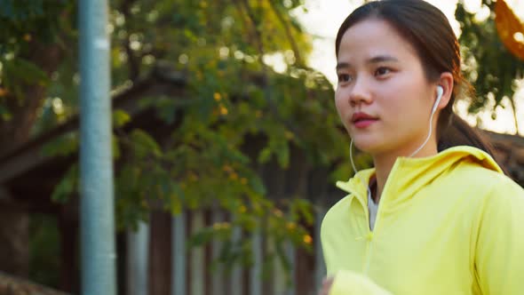 Slow-motion young woman running training workout on the street in the urban.