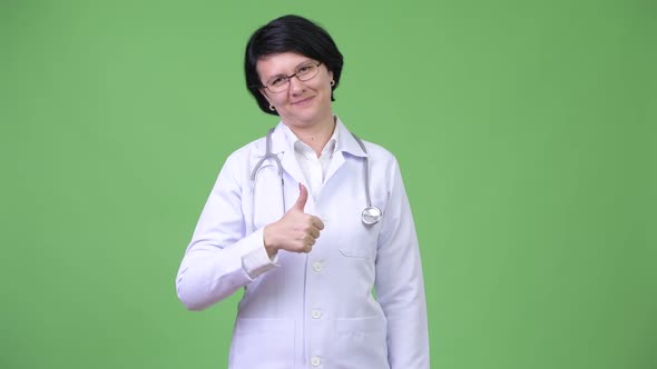 Beautiful Woman Doctor with Short Hair Giving Thumbs Up