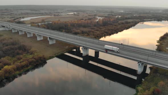 Modern Bridge with a Four Lane Highway Across a Picturesque River in the Evening and Late Autumn