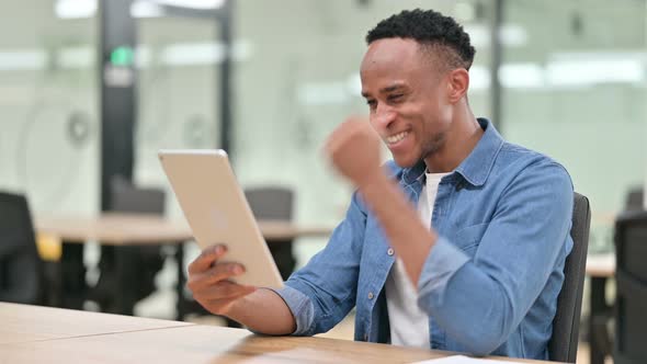 Excited Casual African Man Celebrating Success on Tablet