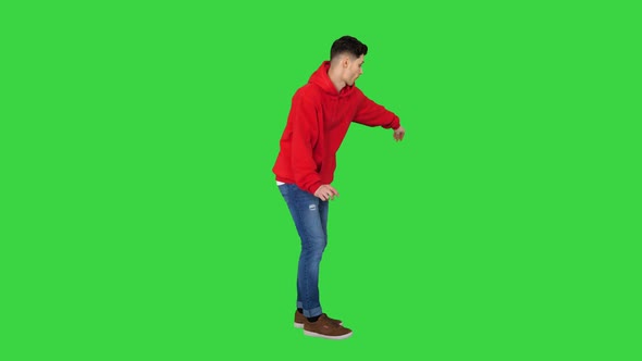 Handsome Young Man Dancing in Red Hoody on a Green Screen, Chroma Key