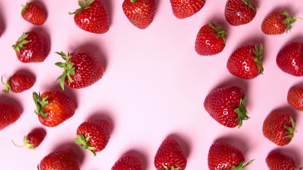 Fresh strawberries on pink background 360 degrees rotation