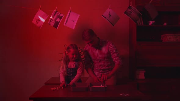 Father and daughter in a red room