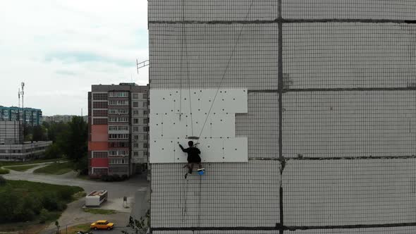 Industrial Alpinism. Aerial View. Work on Outer Insulate Building with Styrofoam