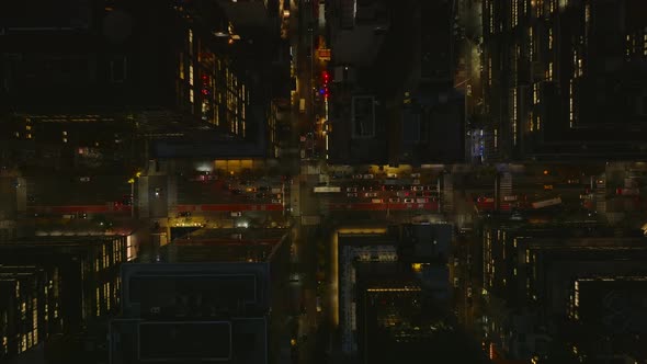 Aerial Birds Eye Overhead Top Down View of Cars Waiting at Crossroads in Night City