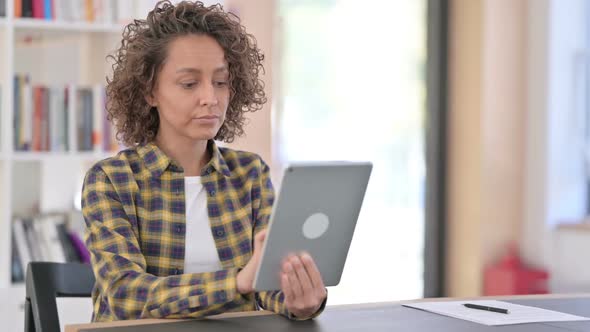 Young Mixed Race Woman Using Digital Tablet at Work