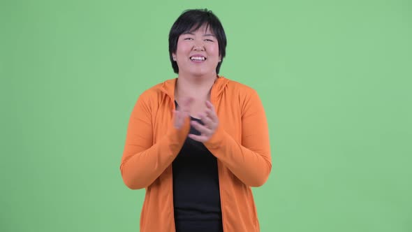 Happy Young Overweight Asian Woman Clapping Hands Ready for Gym