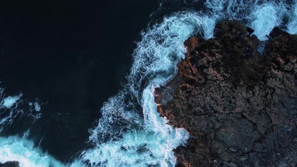 Top Down View Waves Splashes on Rock and Fishers