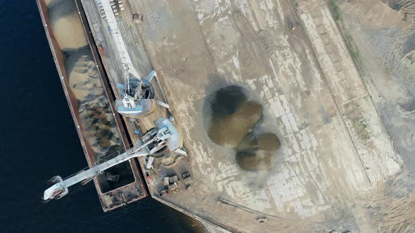 Port Cranes Work, Unloading a Big Barge Full of Crushed Stones