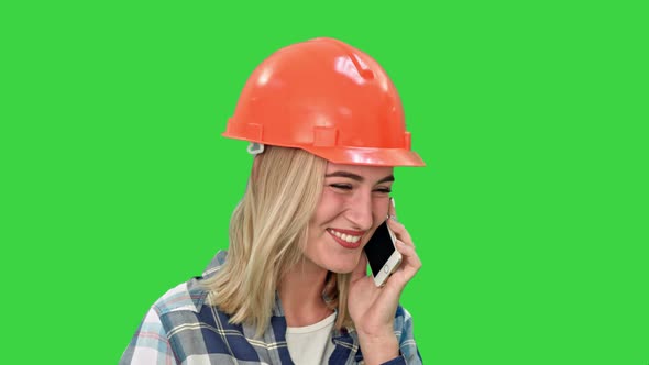 Beautiful Female Engineer in Hardhat Calling Via Cellphone on a Green Screen