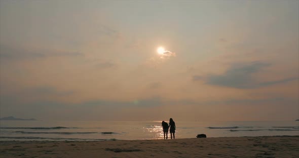 Young Couple Looking Towards the Sun, Against the Sunset, Holding Hands, Go To the Sea