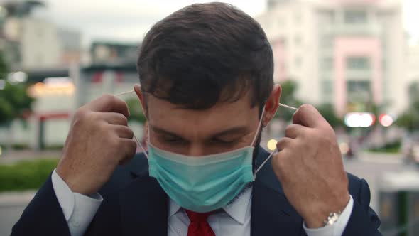 Caucasian Man Removing Covid19 Mask End of Pandemic