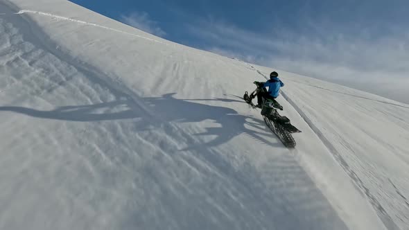 Man Riding on Snow Bike at Winter Mountain Summit Enjoy Outdoor Extreme Sport Activity