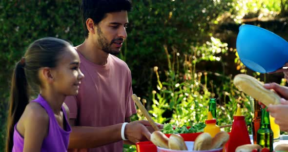 Multi-generation family having meal in park 4k