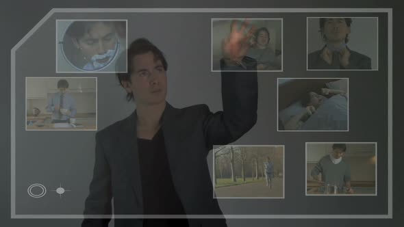 Male touching screen and moving around fragments of his life