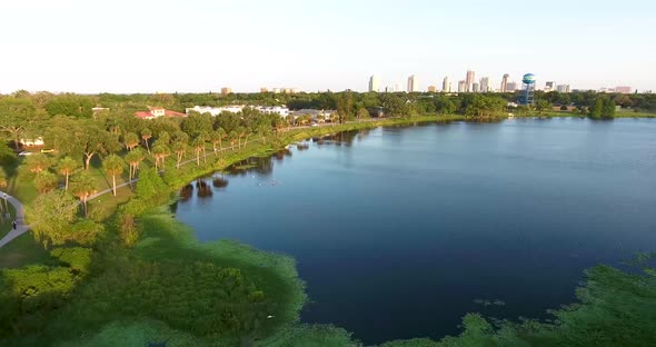 4K Aerial Dolly Video Over Trees and Lake Towards Downtown St Petersburg, FL