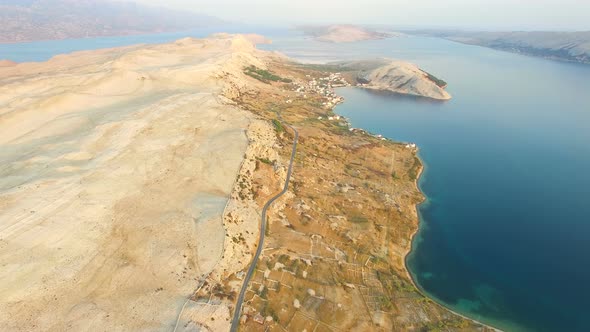 Aerial view of road through barren landscape of Pag island in Croatia alt