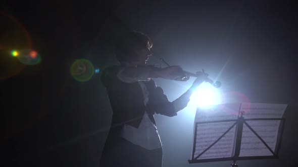 Violinist Performs on Stage with a Lantern