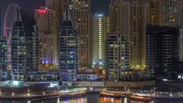 Luxury Yachts Parked on the Pier in Dubai Marina Bay with City Aerial View Night Timelapse