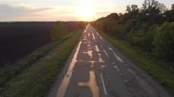 Straight Wet Lonely Road at Sunset After Rain