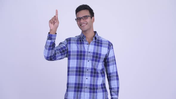 Happy Young Indian Hipster Man Pointing Up