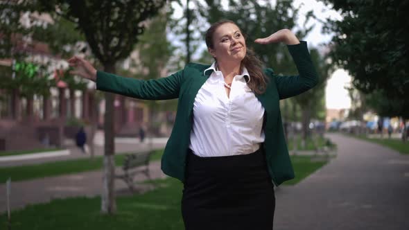 Portrait of Happy Adult Plussize Successful Woman Standing Outdoors in Town Looking Around Smiling