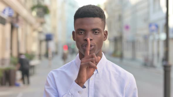 African Man Showing Quiet Sign By Finger on Lips