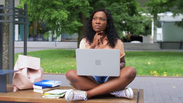 African Student Girl with Laptop and Books in City