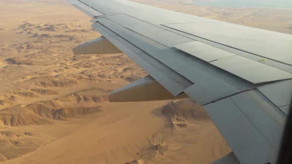 Plane Comes in for a Landing in the Desert the View From the Window on the Wing of the Airplane and