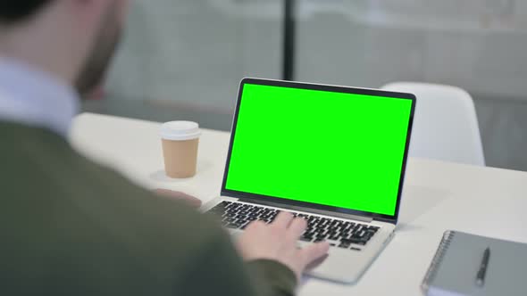 Businessman Using Laptop with Green Screen