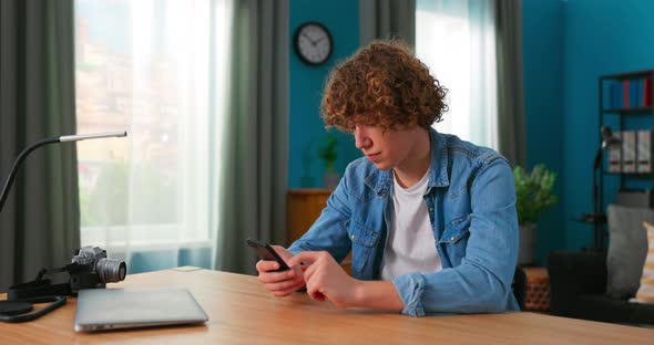 Teenage Boy with Smartphone at Home