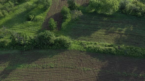 Plowed agricultural fields from above 4K drone video
