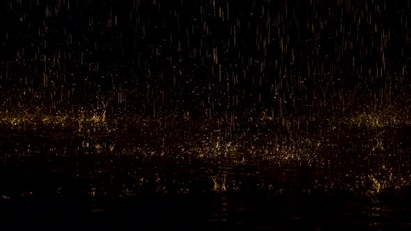Large Yellow Raindrops Drum on the Water and Bounce To the Sides Creating Splashes. Dark Studio with