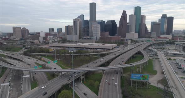 Aerial view of traffic on freeway near downtown Houston on a cloudy day during sunset. This video wa
