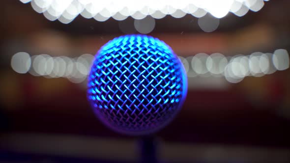 Close Up View of Microphone on Stage Facing Empty Auditorium in Big Concert Hall