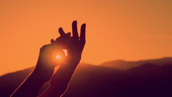 Female Hands Against the Sky Pass Sun Beams