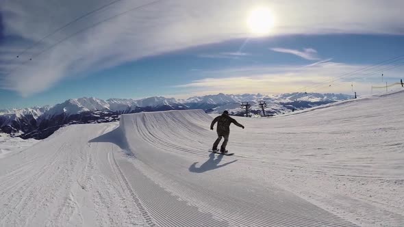 A young man snow boarding.