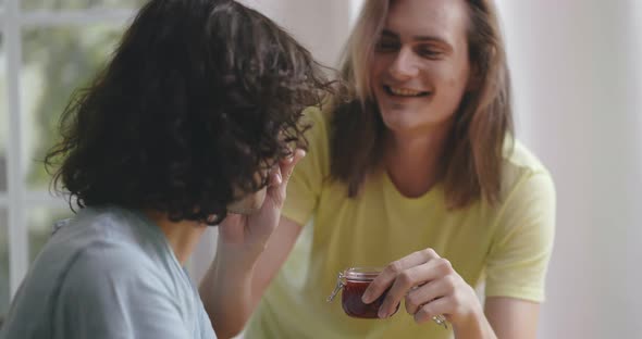 Happy Young Gay Couple Enjoying Tasty Breakfast Together at Home