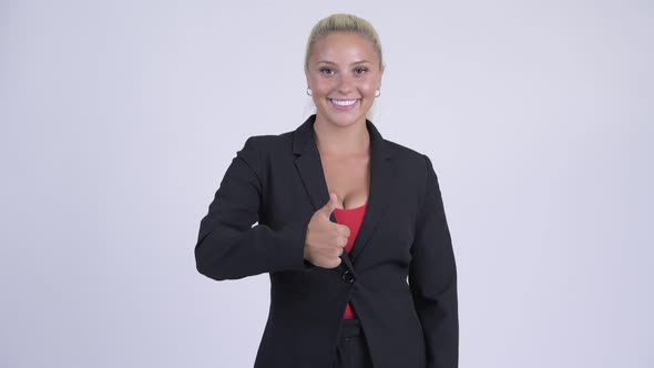 Young Happy Blonde Businesswoman Giving Thumbs Up