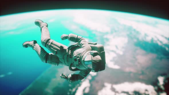 Astronaut Floating Above the Earth Elements of This Image Furnished By NASA