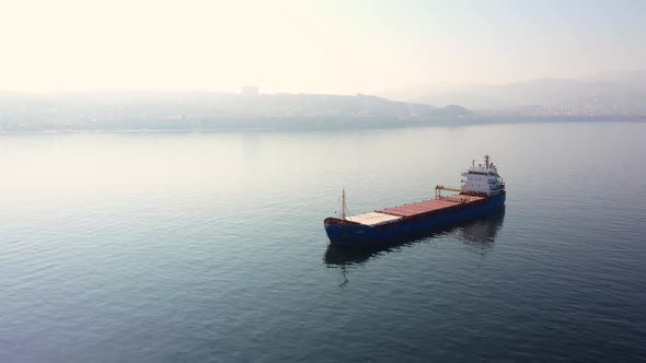 Empty Cargo Ship Vessel with Morning View of City on the Background