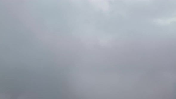 Aircraft passing through dark clouds during descent over Florida. Window view.