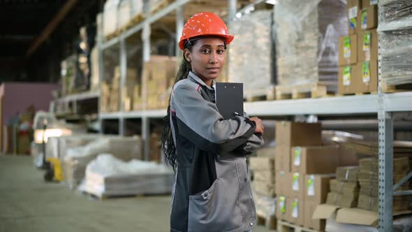 Portrait of a young black woman at work. Worker of production