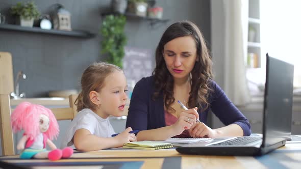 Little Girl with Mom at Distance Home Schooling