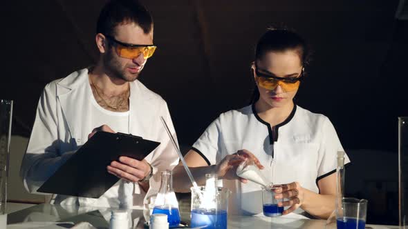 Pair of Chemists are Conducting Experiments in Their Laboratory