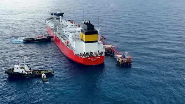 Tugs help the gas tanker to go to sea aerial view 4 K Turkey Alanya