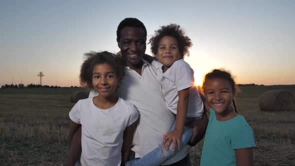 Cheerful African American Family Posing at Sunset